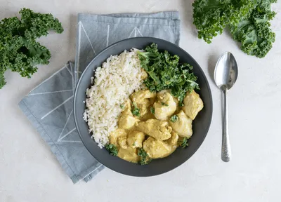 Coconut Butter Chicken topped with Kale and cauliflower rice — 27g protein chef-made ready meal delivered by Foober